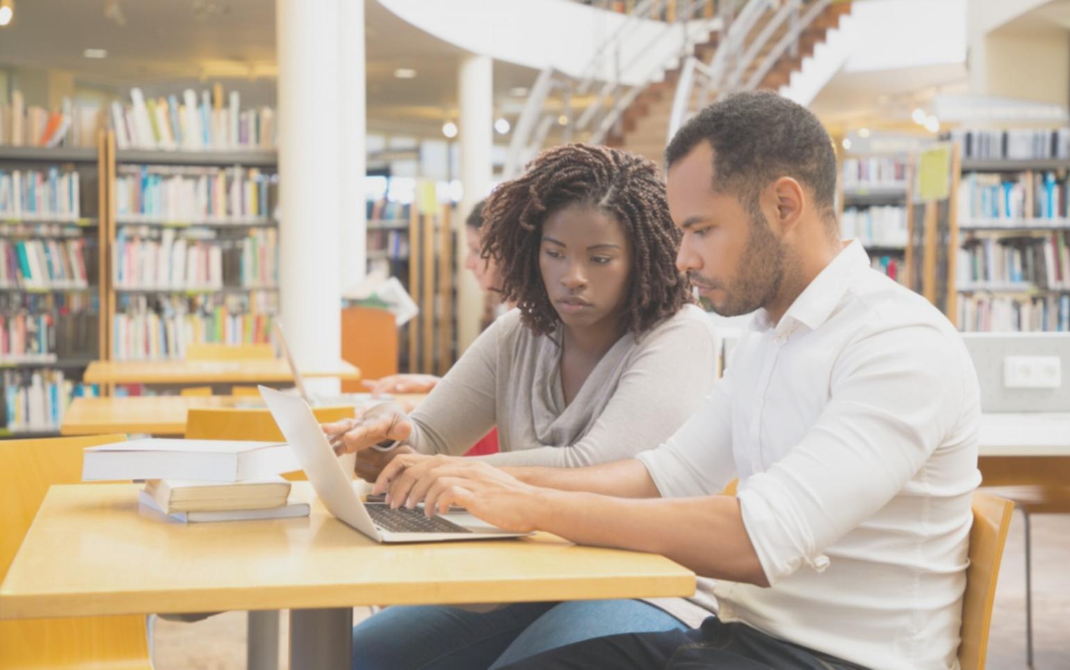 Students working on budget spreadsheets during online session